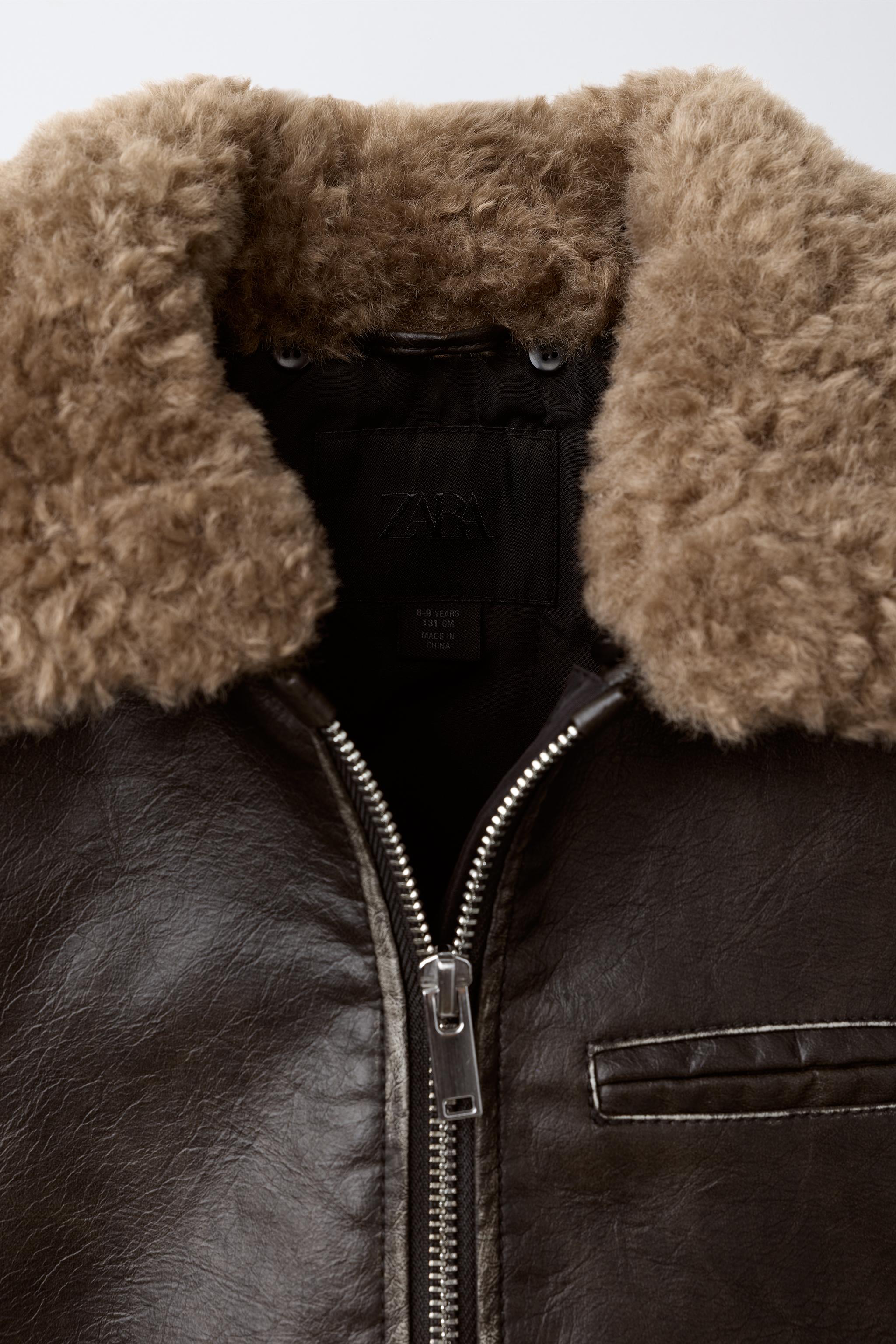 BLOUSON EN MATIÈRE SYNTHÈTIQUE USÉ À COL EFFET FOURRURE