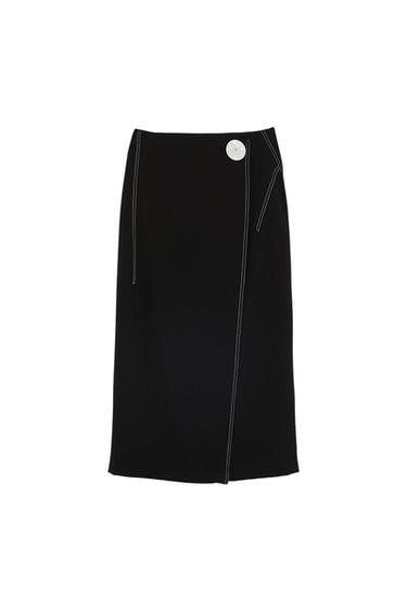 Black skirt with contrasting white stitching and a large white button at the waist, photographed against a white background.
