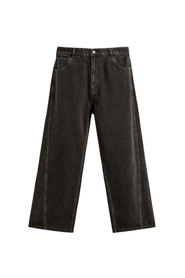 Front view of dark grey relaxed fit trousers, five pockets, twisted side seam, zip and button fastening.