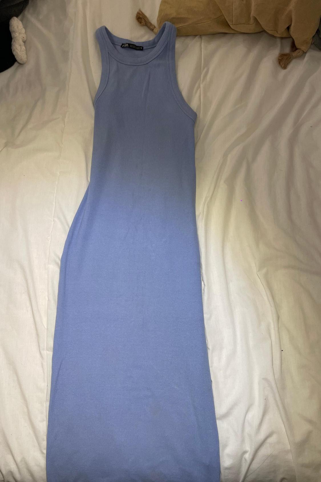 Front view of a long, light blue, sleeveless dress.