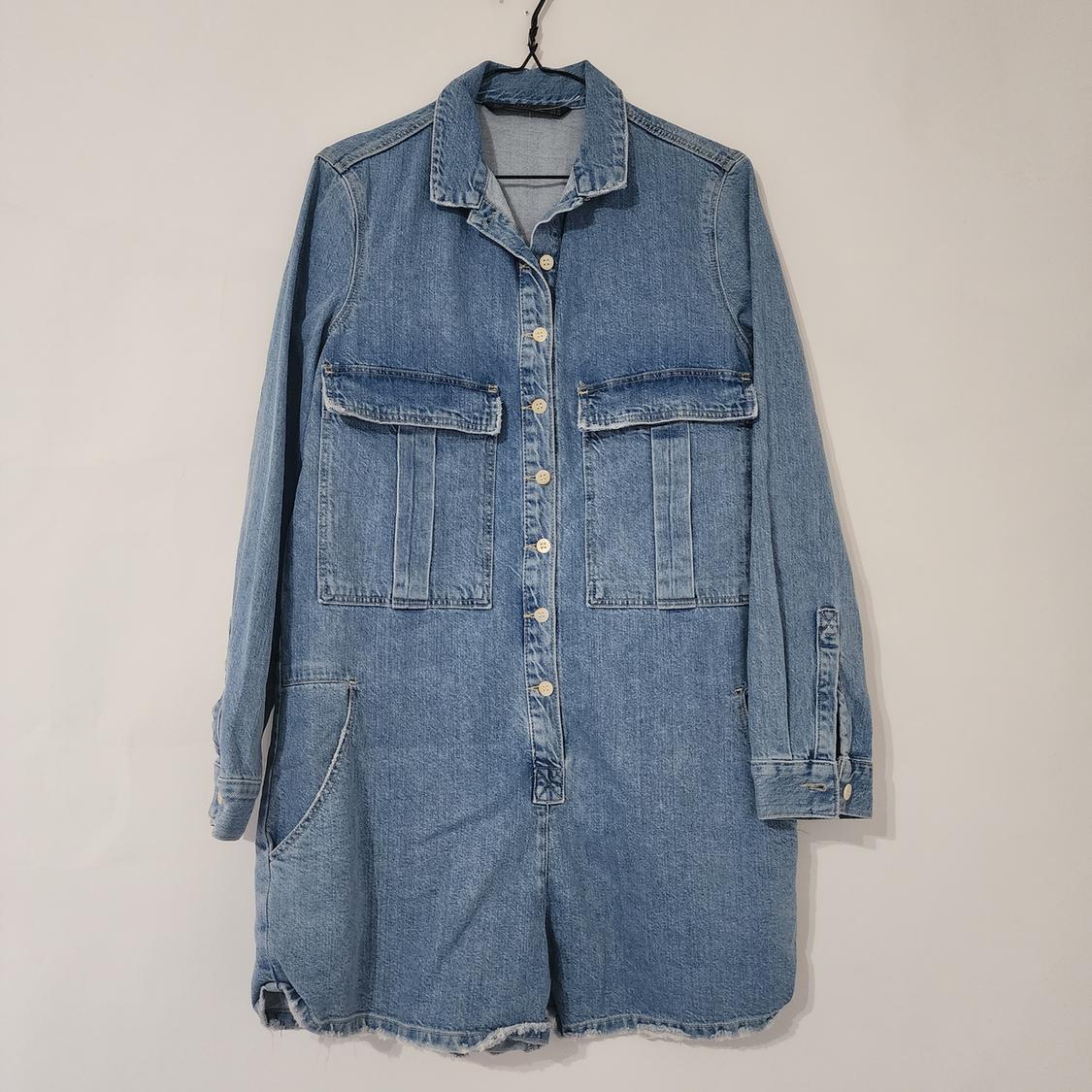 Front view of a blue denim jacket with front pockets and a central button closure.