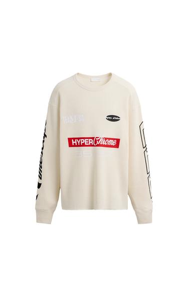Front view of beige t-shirt with 'HyperChrome' text, '35 37', and graphic details on sleeves.