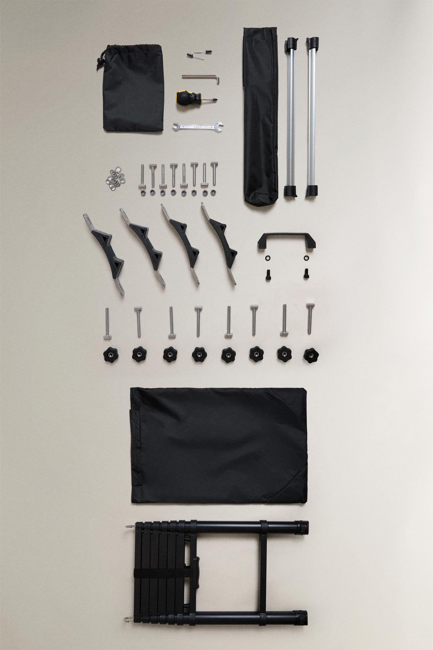 Front view of mounting kit for roof tent. Includes black telescopic ladder, covers, tools, brackets and fixings.