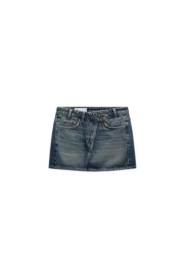 Front view of a denim mini-skirt with front pockets and a waistband with belt loops.