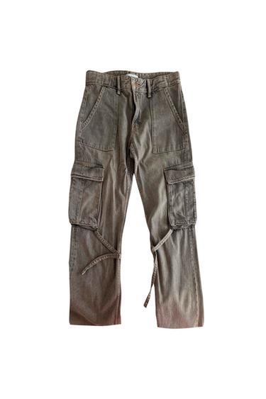 Front view of gray cargo pants with large side pockets and adjustable waistband.