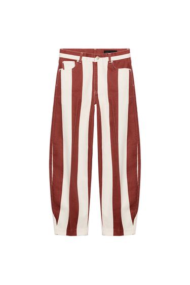 Front view of red and white vertical striped, high-waisted, five-pocket jeans with a zip fly and button fastening.
