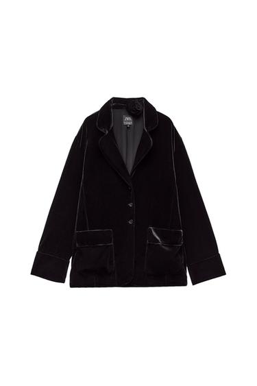 Front view of a black jacket with lapels and front pockets. Flower detail on the collar.