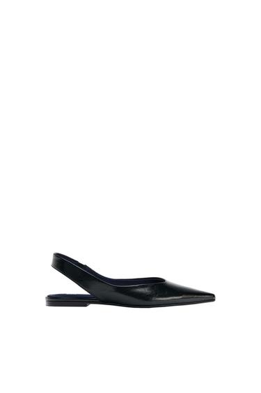 Black pointed-toe slingback flats on a white background.