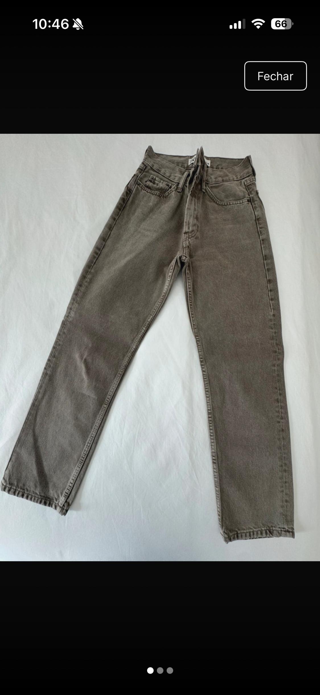 Top view of a pair of grey jeans on crumpled white fabric. Text: 10:46, 66, Close.