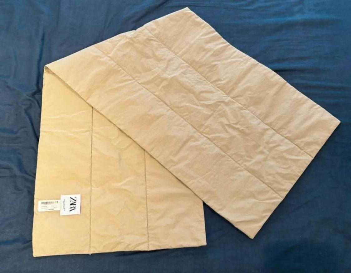 Front view of beige garment with visible 'ZARA' label.