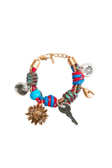 Front view of a multicolor bracelet with sunflower, key, and decorative disc charms.