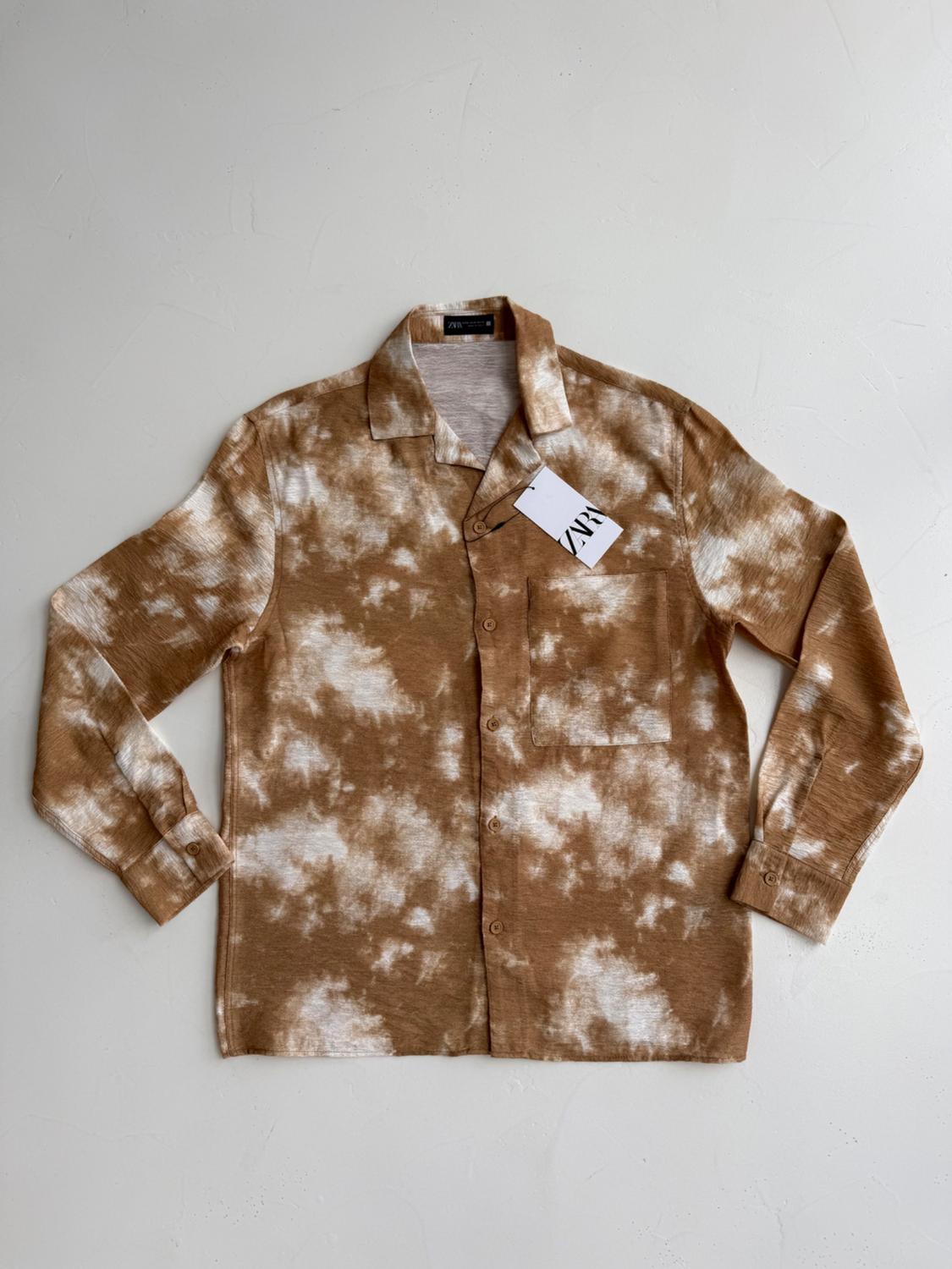 Brown long-sleeved shirt with white tie-dye print on a light background. Visible label with the text "ZARA".