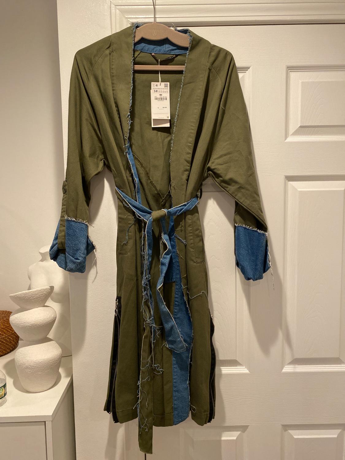 Front view of green dressing gown with distressed blue detailing, matching belt and visible label.