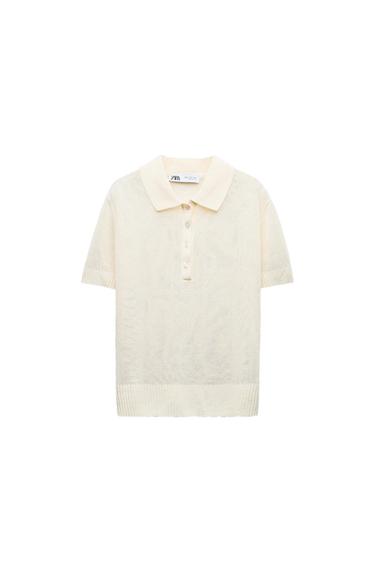 Beige short-sleeved polo shirt with front buttons. Visible label with text: "ZARA". White background.
