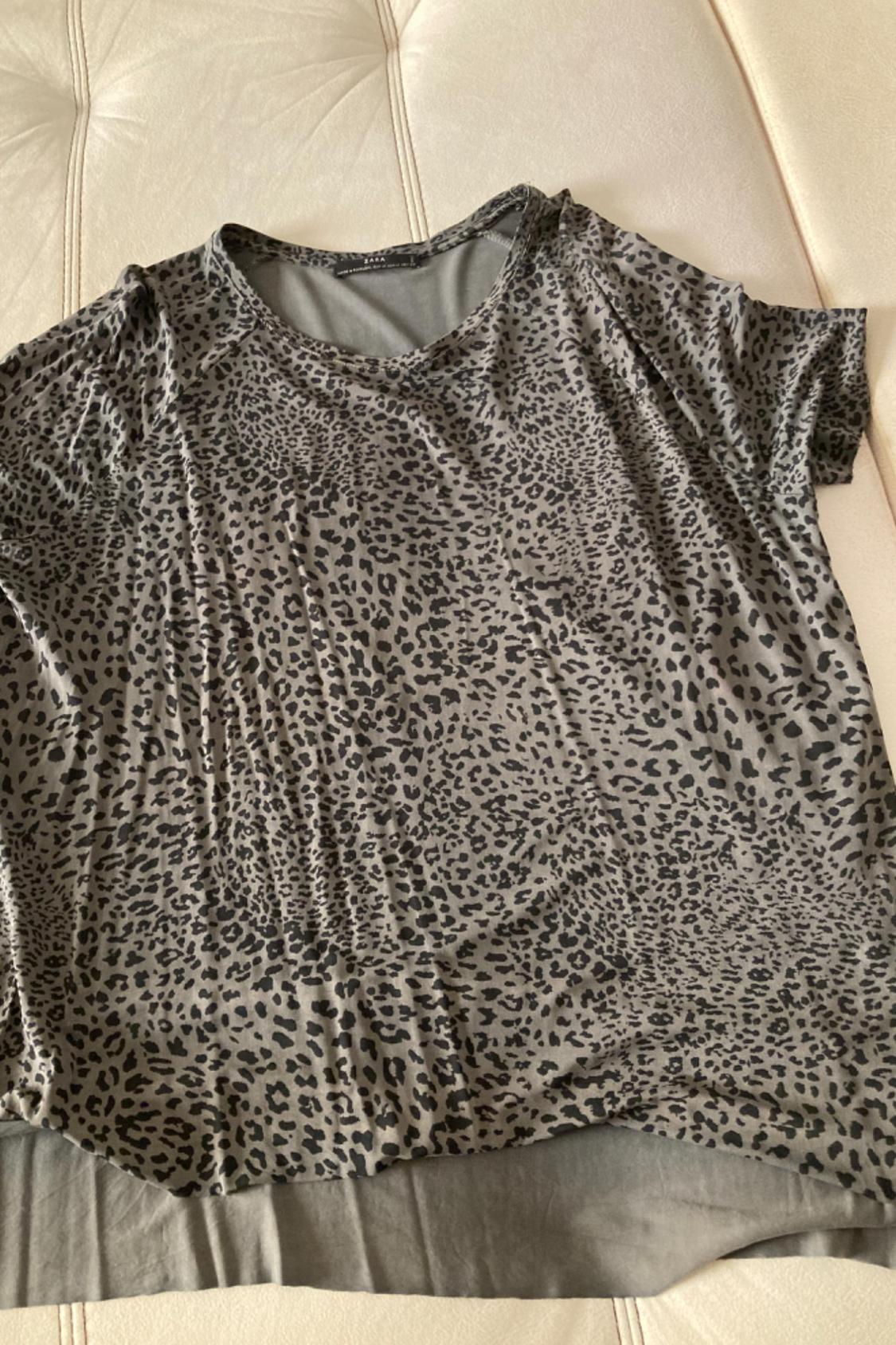 Front view of a grey t-shirt with a leopard print.