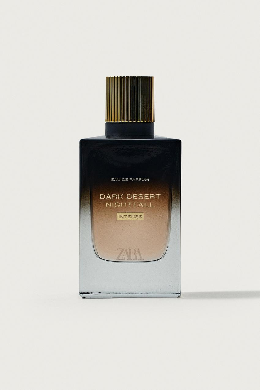 Vista frontal de frasco de perfume con degradado negro, tapón dorado estriado y texto 'EAU DE PARFUM DARK DESERT NIGHTFALL INTENSE'.