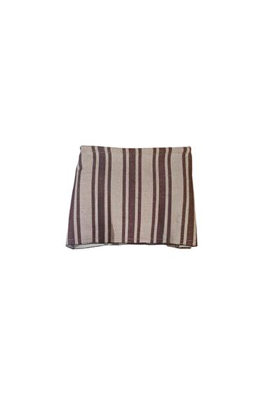 Brown and beige vertical stripe mini skirt on a white background. Simple and modern design, ideal for a casual look.