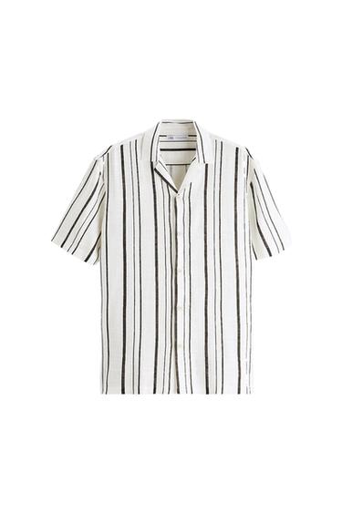 Short-sleeved white shirt with dark vertical stripes and button closure.
Label on the neck with the text ZARA. White background.