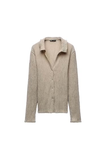 Beige long-sleeved shirt with wrinkled texture and front buttons. Classic collar. White background.