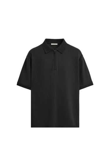 Black short-sleeved polo shirt with a front zip and classic collar, on a white background.