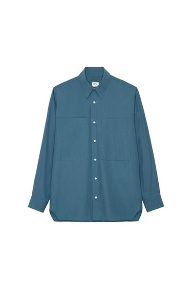 Teal long-sleeved shirt on a white background. Collar, button fastening, two chest pockets and label with ZARA text.