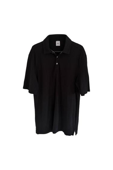 Black short-sleeved polo shirt hanging on a white background, with visible label on the collar.