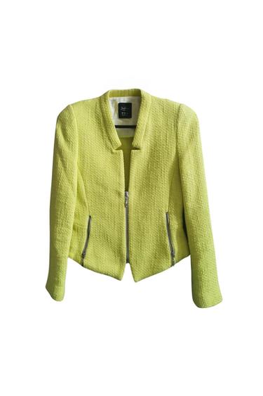 Front view of a yellow jacket with a zip and side pockets.