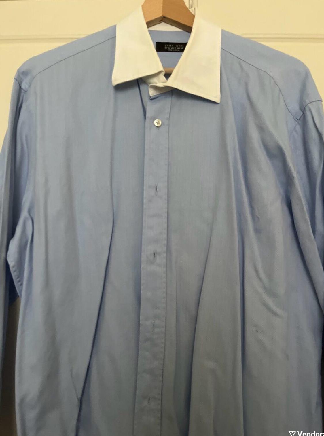 Front view of a blue shirt with a white collar, central button fastening and long sleeves.