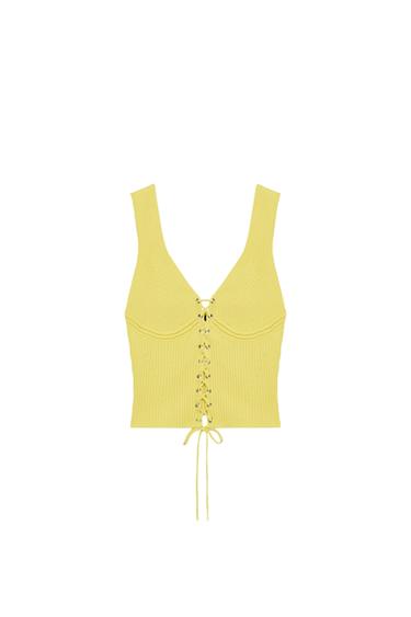 Front view of a fitted yellow top with a V-neckline, wide straps, and a criss-cross lace-up front closure.