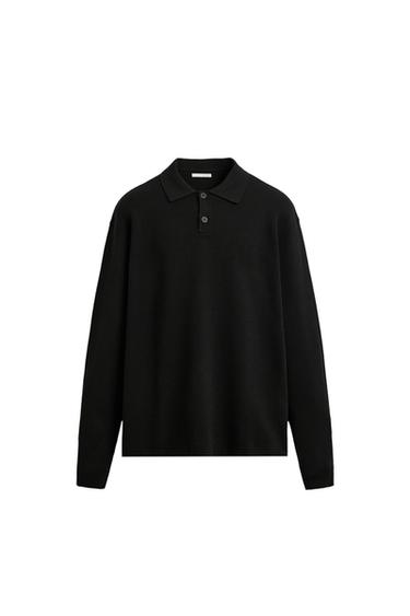 Front view of a black, long-sleeved polo shirt featuring a collar, button-up front fastening, and a hem with side vents.