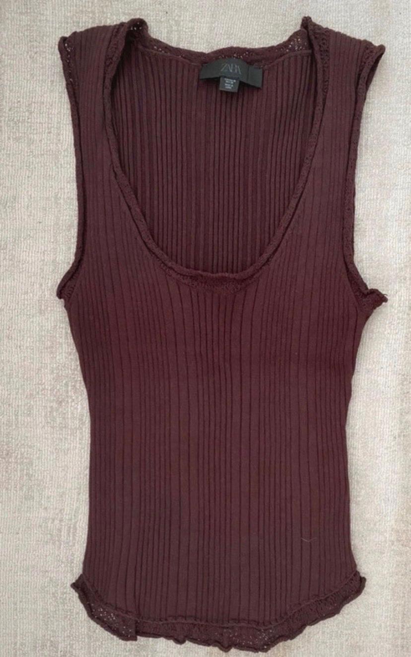 Burgundy ribbed knit camisole top with a round neckline and lace trims. Visible ZARA label. Presented on a light background.