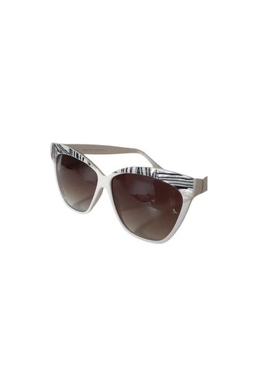 Sunglasses with a black and white frame, dark lenses.