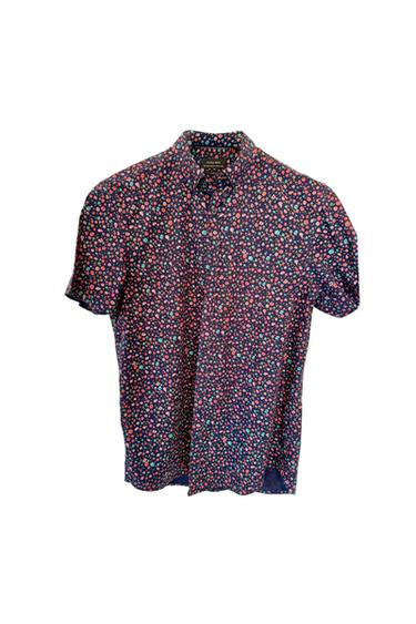 Short-sleeved shirt with a small floral print in red, blue, and white on a dark blue background.