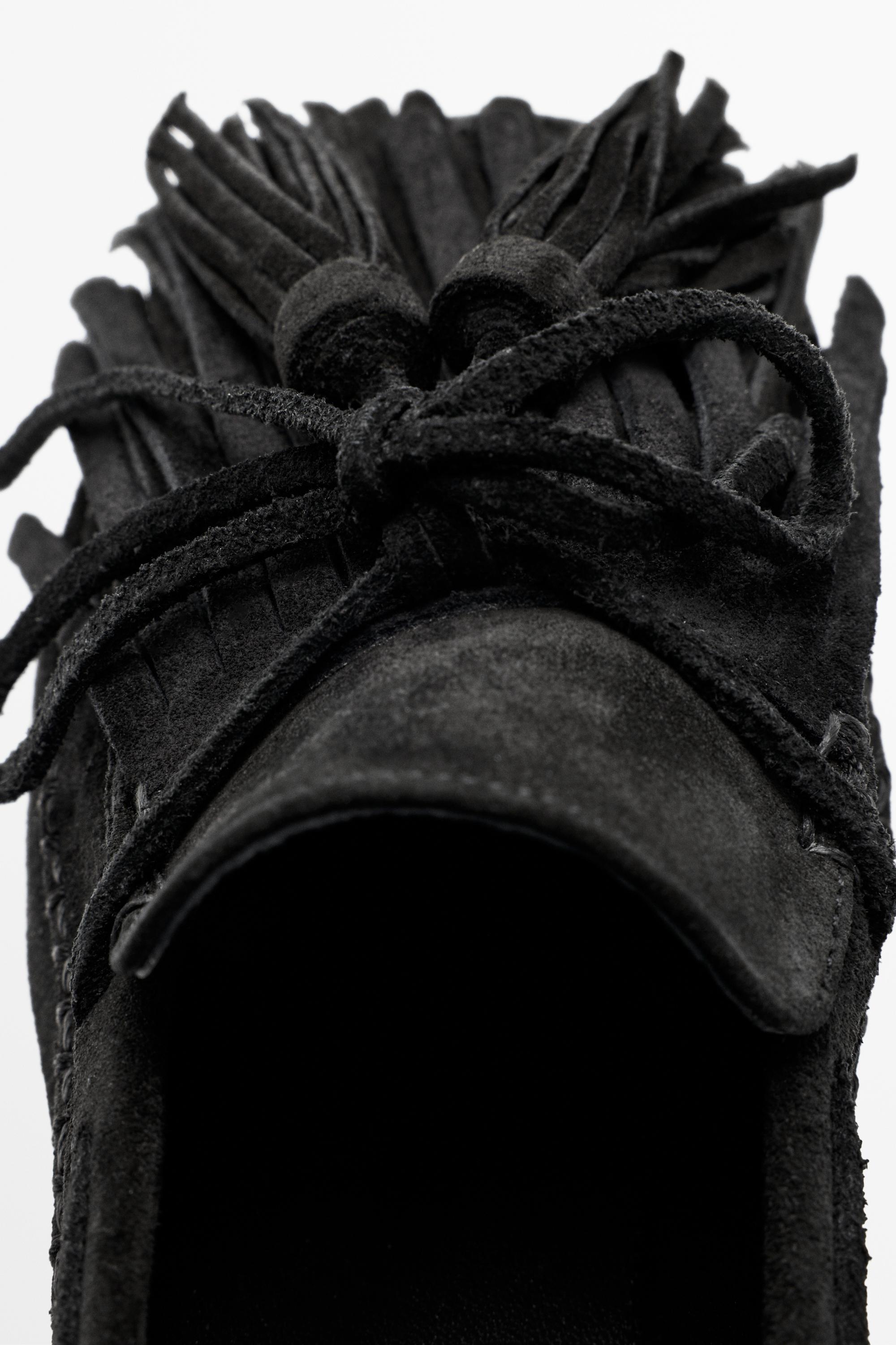 Mocassin en cuir à franges et pompons