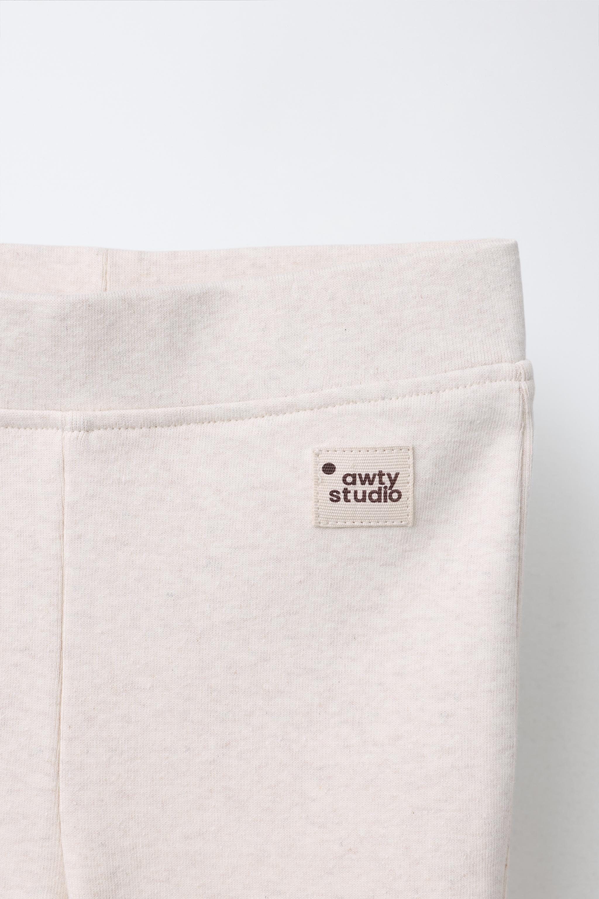 LABEL DETAIL INTERLOCK FLARE LEGGINGS