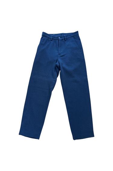 Front view of blue trousers with side pockets and button fastening.