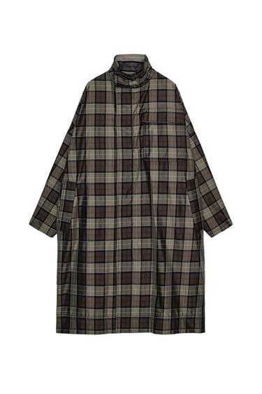 Oversized long checked coat in shades of brown and grey. Features a high neck and a chest pocket, displayed on a white background.