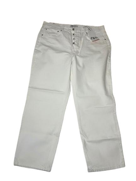 White denim trousers with visible buttons and a swing tag on the front right pocket, against a white background.