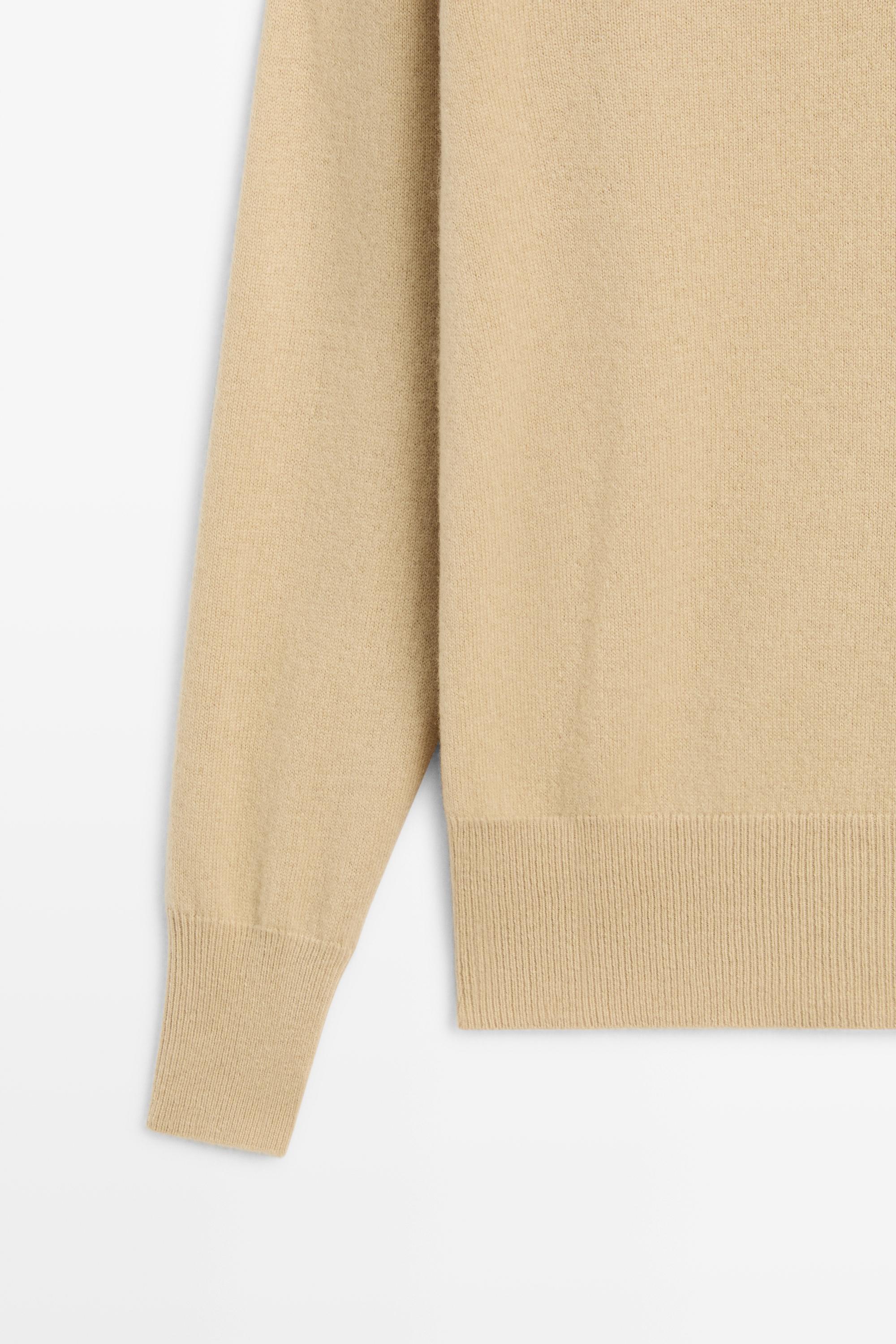 High neck knit sweater with button detail