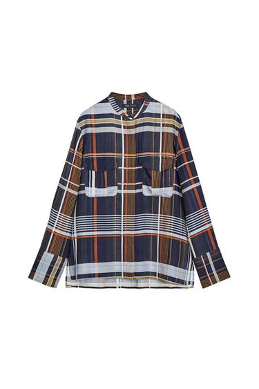 Front view of a multicoloured checked shirt with a mandarin collar, long sleeves and patch pockets with flaps on the chest.
