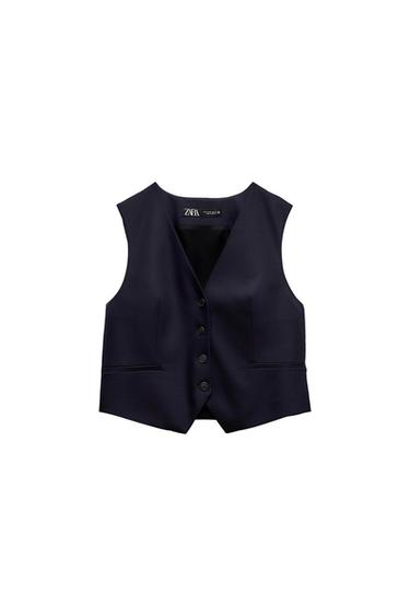 Sleeveless black vest with front buttons and pockets, visible label with the text "ZARA" on the inside of the neck.