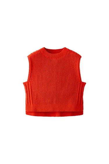 Orange sleeveless knitted waistcoat with a round neck. Textured design with ribbed trims, photographed against a white background.