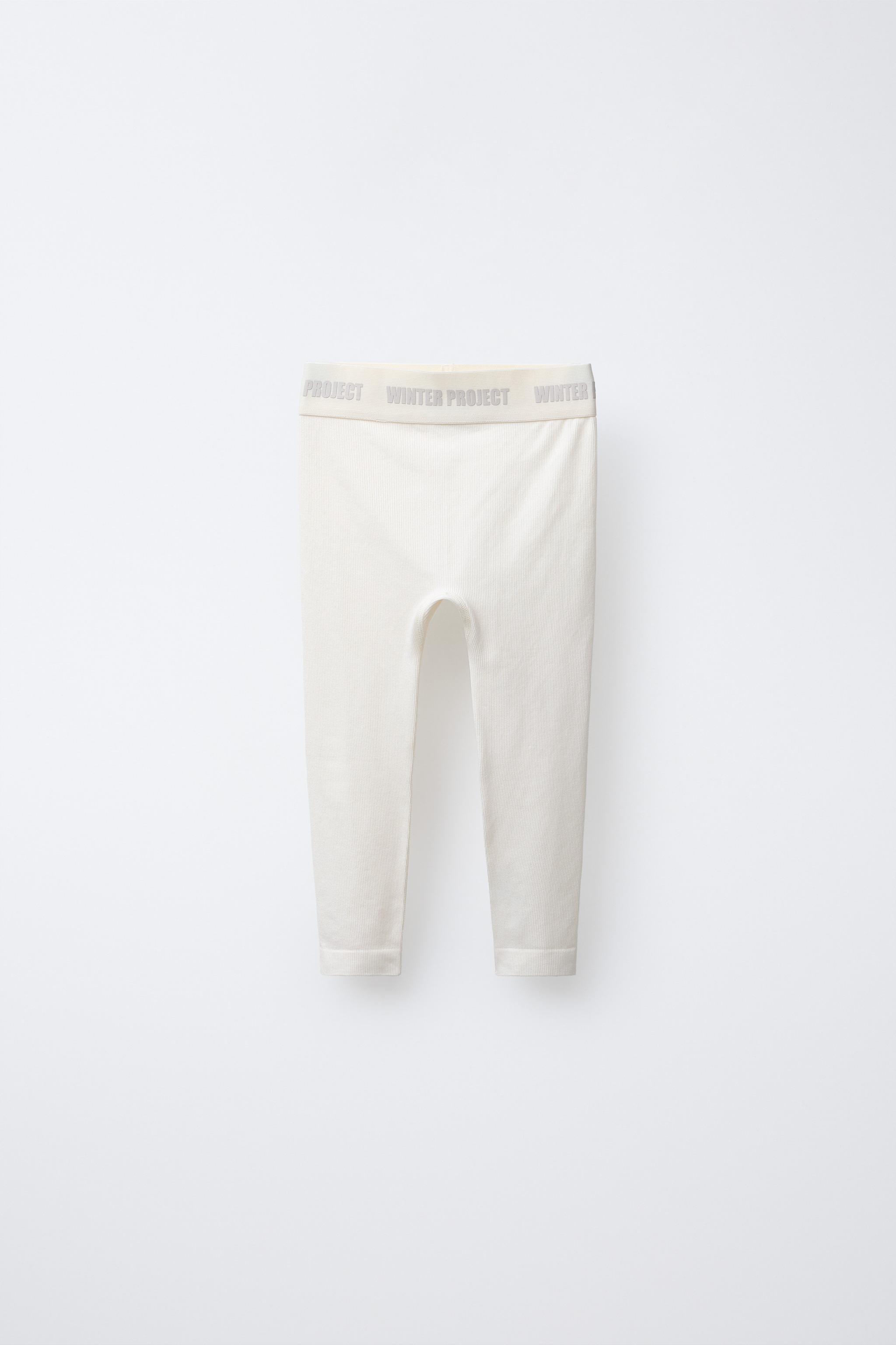 LEGGING CÔTELÉ AVEC INSCRIPTION EN RELIEF