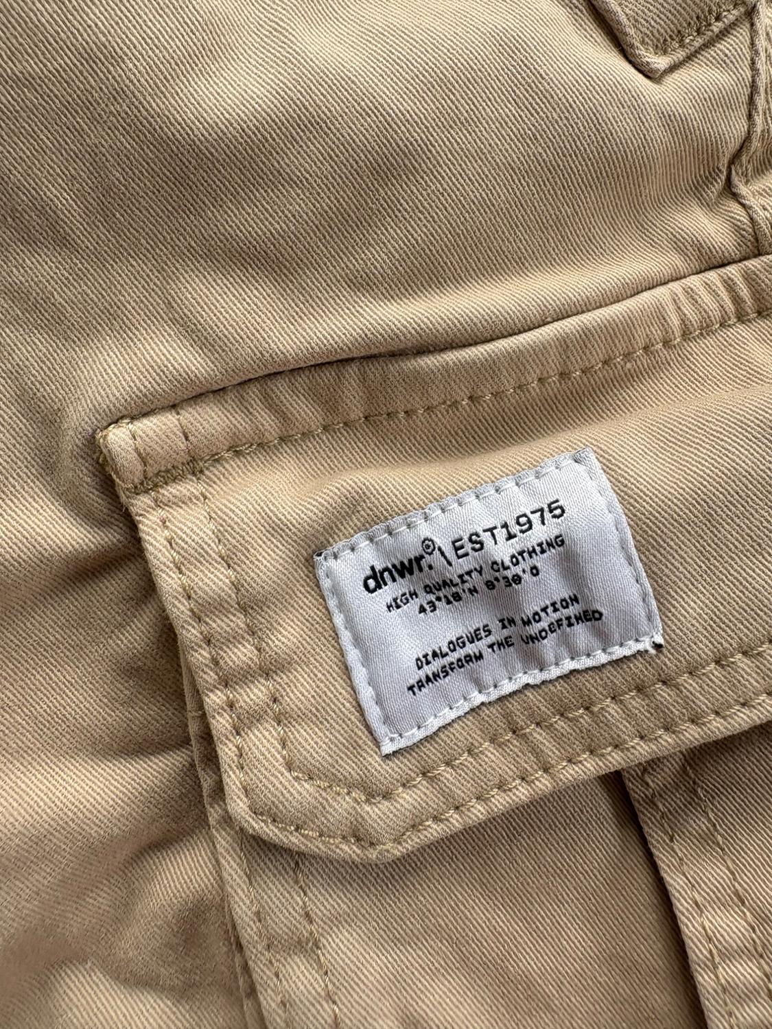 Elastic waistband shorts. Front pockets and back flap pockets. Flap patch pockets at legs. Front zip and button closure. - Image 4