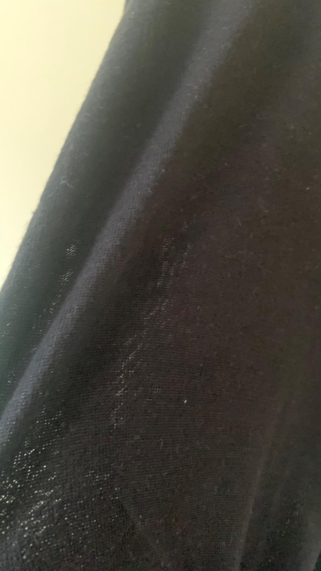 Textured black fabric detail.