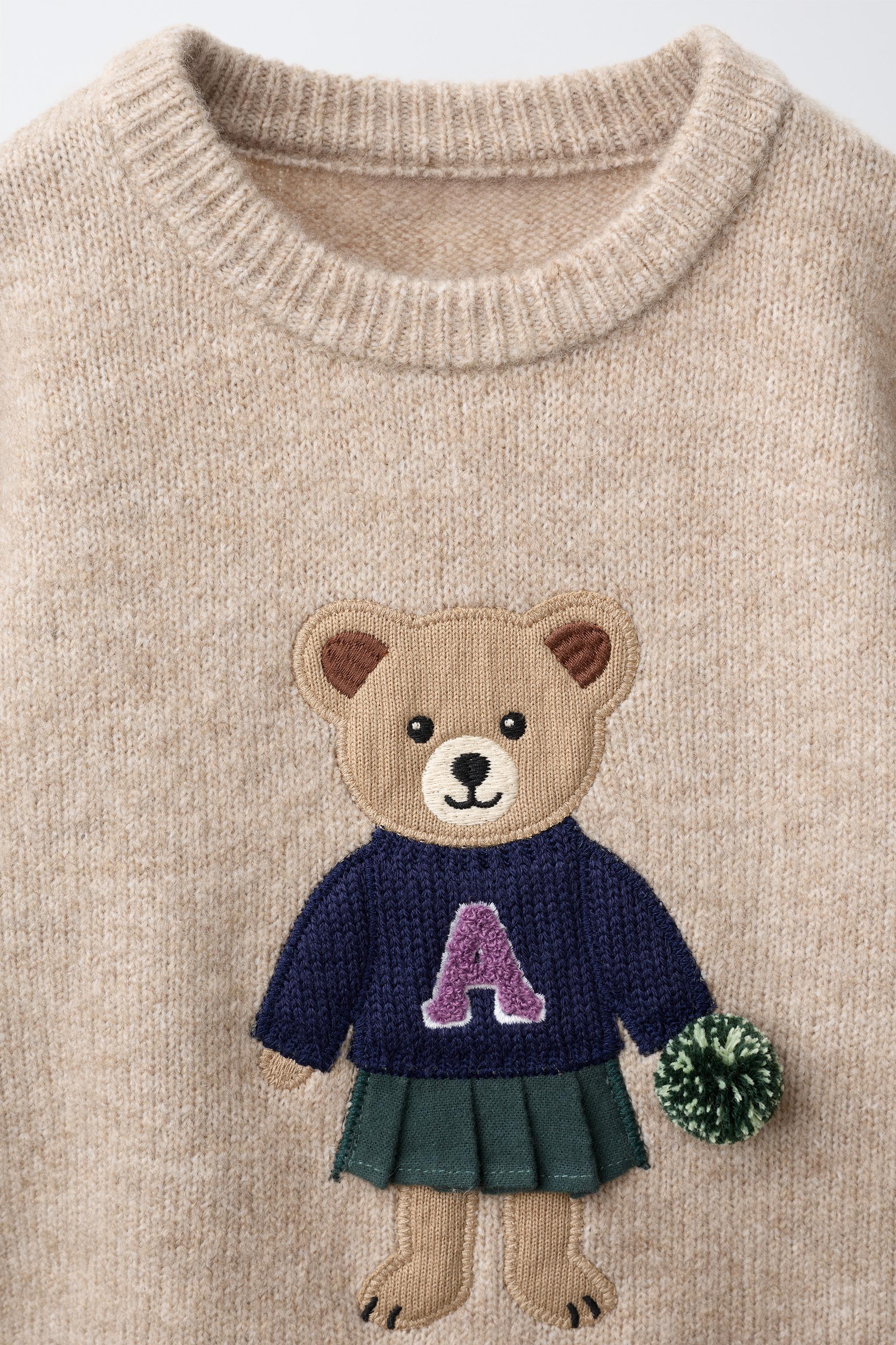 PULL EN MAILLE OURSONNE POMPOM
