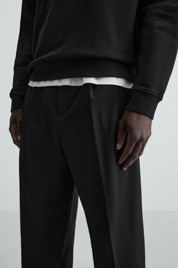 WIDE FIT PLEATED TROUSERS