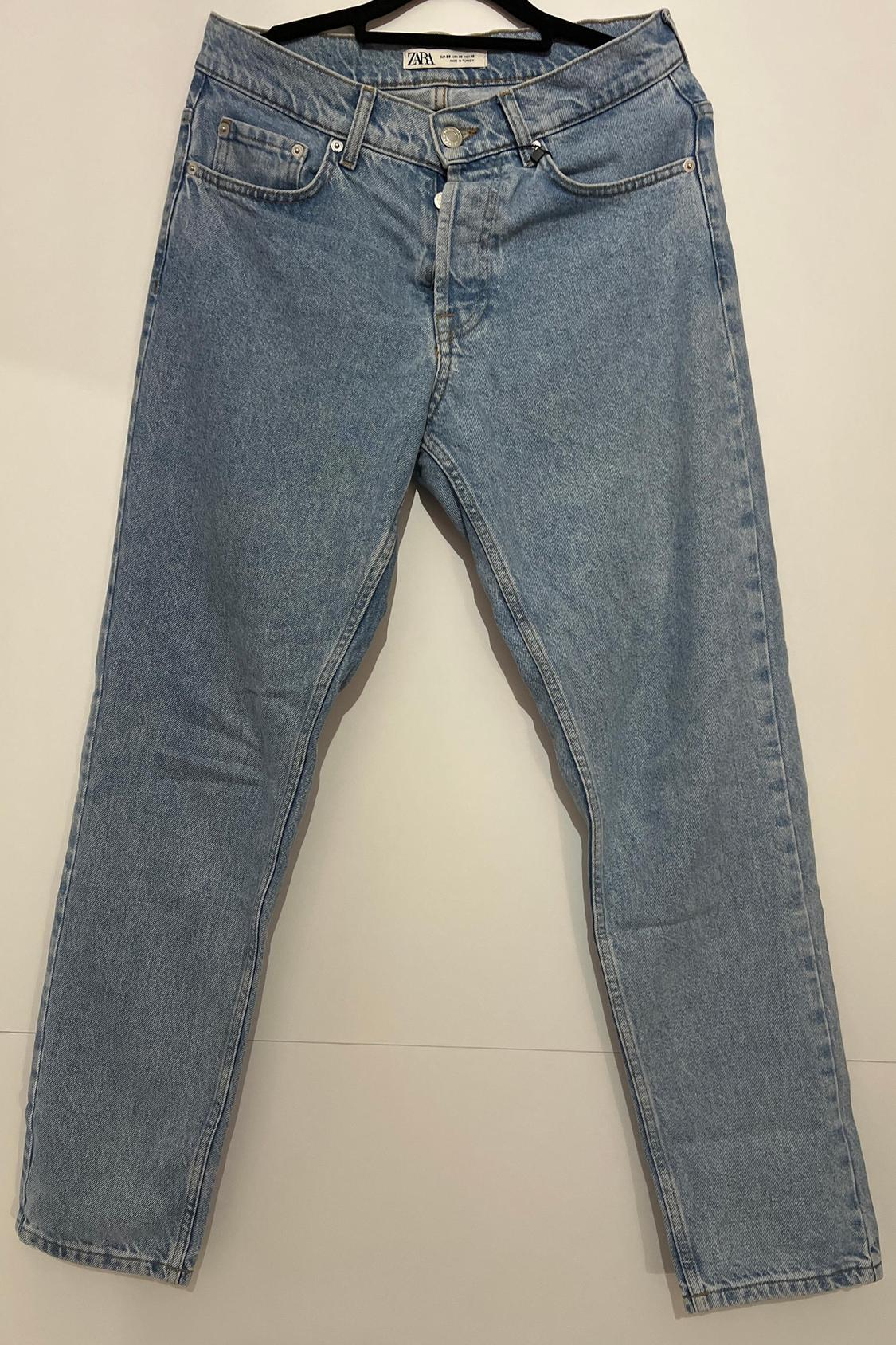 Front view of blue jeans with front pockets and belt loops.