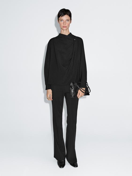 Blouse with crossover detail and button