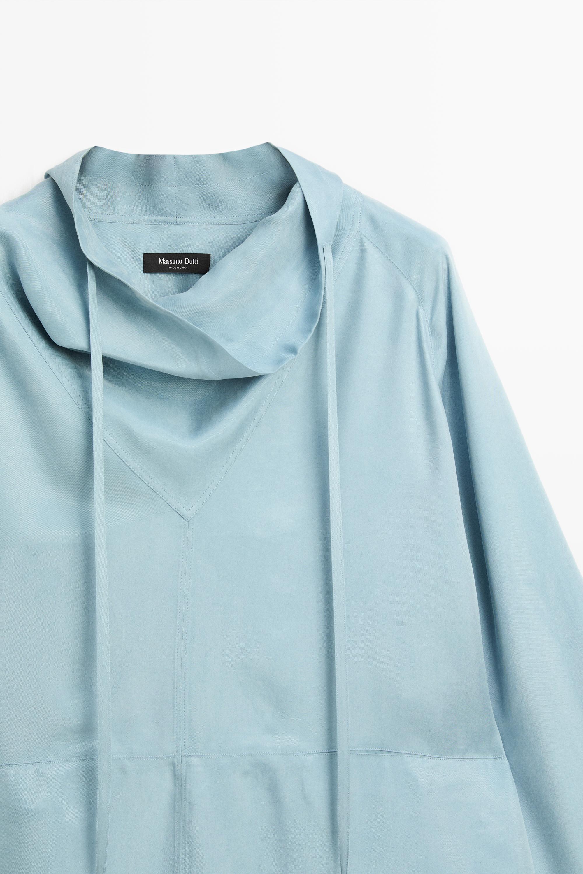 Flowing shirt with high collar and drawstring detail